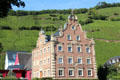 Mönchhof building with Dutch style facade set against vineyard. Ürzig, Germany.