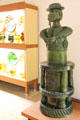 Green glazed earthenware heating oven in form of man smoking pipe from Kröning at Bavarian National Museum. Munich, Germany