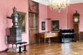 Stove, musical instruments & standing clock in ornate wooden case in Municipal Art Gallery at Schaezler Palace. Augsburg, Germany.
