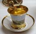 Cup & saucer with view of Augsburg & gold trim made by Nymphenburg Porcelain of Munich at Maximilian Museum. Augsburg, Germany.