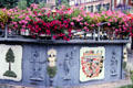 Cascading flowers & wall with ornamental carvings in historic center. Nördlingen, Germany