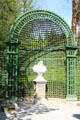Niche-like pergola section in which statue is placed in formal garden at Linderhof Castle. Ettal, Germany.