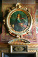 Detail of fireplace with portrait & clock in Chateau. Ancy-la-Franc, France.