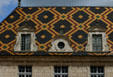 St Louis facade & tiled roof in courtyard of Hotel Dieu. Beaune, France