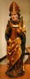 Wooden statue of St Nicholas with three bags of gold from upper Rhine in Unterlinden Museum. Colmar, France.