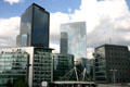 Black Adria & white Egée towers over low-rise residences at La Défense. Paris, France.