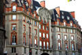 Highly ornamented red-trimmed building on Left Bank. Paris, France.