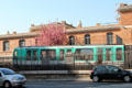 RATP metro train beside roadway. Paris, France.