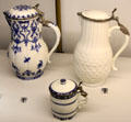 Porcelain water pitchers & mustard pot made by Manuf. Saint-Cloud of Paris with silver fittings by Paul le Riche at Museum of Decorative Arts. Paris, France.