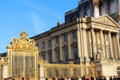 Northern chapel wing of Versailles Palace flanking Royal Court closed off by gilded gates. Versailles, France.