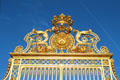 Upper detail of Royal Court gilded gates at Versailles Palace. Versailles, France.