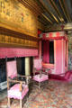 Fireplace, armchairs & canopy bed in Cesarof Vendôme's bedroom at Chenonceau Chateau. Chenonceau, France.
