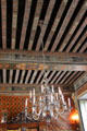 Dining room Dutch silver plated chandelier hangs from painted beams at Cheverny Chateau. Cheverny, France.