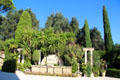 Shrubbery & carved stone in garden at Villa Ephrussi de Rothschild. Saint Jean Cap Ferrat, France.