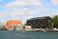 "Communiquez" headquarters with orange Les Salins offices beyond along Saône River in Confluence district. Lyon, France.