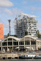 Ycone housing tower over Saône riverside restaurants. Lyon, France.