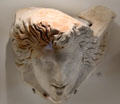 Roman marble sarcophagus corner with comedic theater face at Musée de la Romanité. Nimes, France.