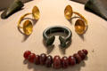 Hoard of bronze axeheads, gold dress fasteners, bronze bracelet & amber beads from Mountrivers at National Museum of Ireland Archaeology. Dublin, Ireland.
