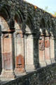 Cloister enclosure with unique series of double columns framing flat carvings at Jerpoint Abbey. Ireland.
