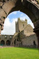 Transept tower seen through arches of cloister at Jerpoint Abbey. Ireland.