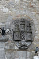 Carved coat of arms with archers atop castle on Kilkenny city hall. Kilkenny, Ireland.