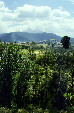 Landscape along route from Mexico City to Puebla with Popocatépetl volcano smoking on horizon. Mexico.
