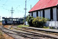 Street car rounds curve at Ferrymead Heritage Park, an open-air village, in Christchurch. New Zealand.
