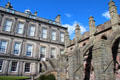 Flying buttresses of Holyrood Abbey behind Holyrood Palace. Edinburgh, Scotland.