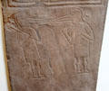 Symbolic Pictish bird-headed men pecking a human head on Papil cross at National Museum of Scotland. Edinburgh, Scotland.