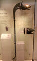 Reconstruction of northern Scottish Carnyx war trumpet whose sound in battle lead Romans to call their enemies Carnyx beside original head from Deskford at National Museum of Scotland. Edinburgh, Scotland.