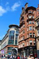 Brittania Building red sandstone commercial building with octagonal corner with Buchanan Galleries beyond on Buchanan St. Mall. Glasgow, Scotland.
