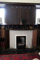 Library fireplace with C.R. Mackintosh cube clock on mantle at Hill House. Helensburgh, Scotland.