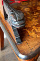 Carved dragon handle on inlaid armchair at Pollok House. Glasgow, Scotland.