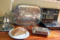 Serving dishes in poop cabin of Glenlee Tall Ship. Glasgow, Scotland.