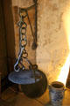 Cast iron girdle hanging from sway marks time when Culross had Royal Warrant for monopoly on making wrought iron girdles in High Hall at Culross Palace. Culross, Scotland.