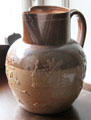 Brown ceramic pitcher embossed with windmill by Royal Doulton at Manderston House. Duns, Scotland.