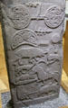 Pictish cross-slab detail of double paddle over crescent with swirls above animal scenes at St Vigeans Museum. Arbroath, Scotland.