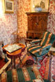 Peacock parlour with tripod / trefoil table with arm chairs at Castle Fraser. Aberdeenshire, Scotland.