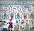 Sampler by young girl shows English red coat slaying a kilted Jacobite at Culloden at Culloden Moor Visitor Centre. Culloden Moor, Scotland.