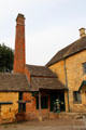 Tall red brick chimney of Old Mill. Lower Slaughter, England