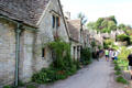 Visitors stroll along Arlington Row pathway. Bibury, England.