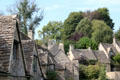 Steep slate roofs on weavers' cottages & other homes along Arlington Row. Bibury, England