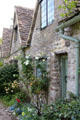 Flowers & plantings gracing front of weavers' cottages. Bibury, England.