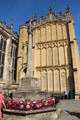 War memorial built by William D Gough, standing on SW side of Church of St John Baptist with rolls of honor carved into face of church porch. Cirencester, England