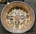 Slip decorated dish showing crowned heads of restoration made in North Straffordshire at Potteries Museum & Art Gallery. Hanley, Stoke-on-Trent, England.