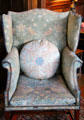 Strawberry Thief fabric on wing-back armchair fixed with brass studs by Morris & Co at Wightwick Manor. Wolverhampton, England.