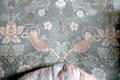 Detail of Strawberry Thief fabric on wing-back armchair by Morris & Co at Wightwick Manor. Wolverhampton, England.