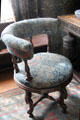 Tulip & Rose woven wool fabric by Morris & Co on padded round revolving desk chair in Great Parlor at Wightwick Manor. Wolverhampton, England.
