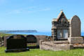 Gravestones & Antrim coast at Ballintoy Parish Church. Ballintoy, Northern Ireland.