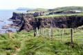 Dunluce Castle perched on Causeway Coast cliffs. Northern Ireland.